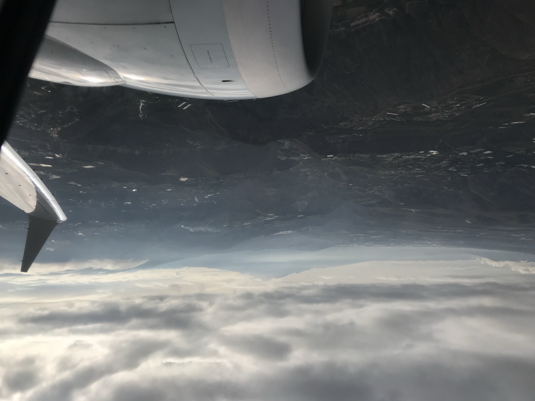The wing of a plane over the Andes
